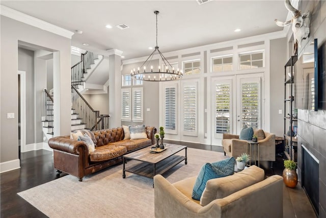 living area featuring stairway, visible vents, wood finished floors, and ornamental molding