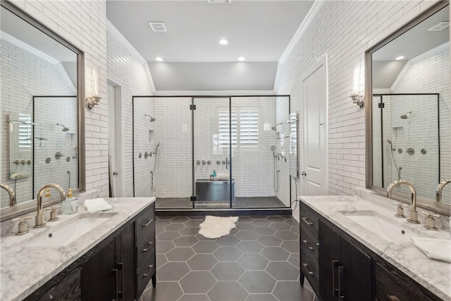 full bath featuring two vanities, a sink, a shower stall, and tile patterned floors