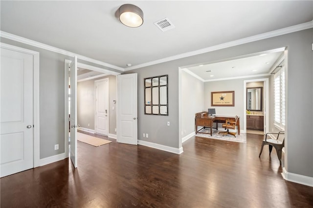 interior space with baseboards, wood finished floors, visible vents, and crown molding