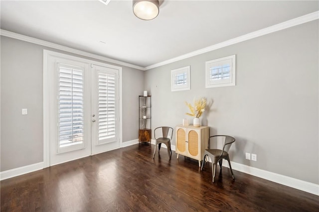 sitting room with a healthy amount of sunlight, crown molding, baseboards, and wood finished floors