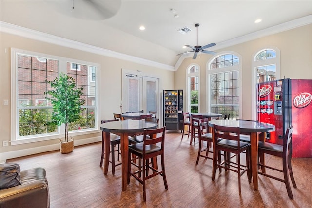 1198 Jones Butler Rd, College Station, TX 77840 - dining space with a ceiling fan, crown molding, plenty of natural light, wood finished floors, and lofted ceiling