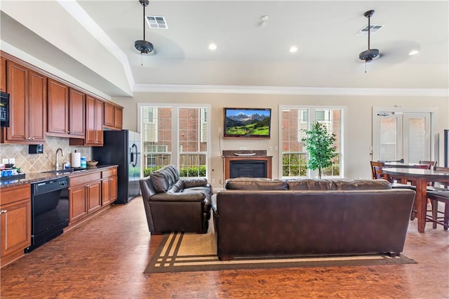 1198 Jones Butler Rd, College Station, TX 77840 - living room featuring crown molding, wood finished floors, a glass covered fireplace, and healthy amount of natural light