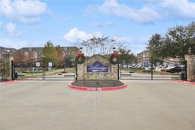 1198 Jones Butler Rd, College Station, TX 77840 - view of concrete road with a gate, curbs, and a gated entry
