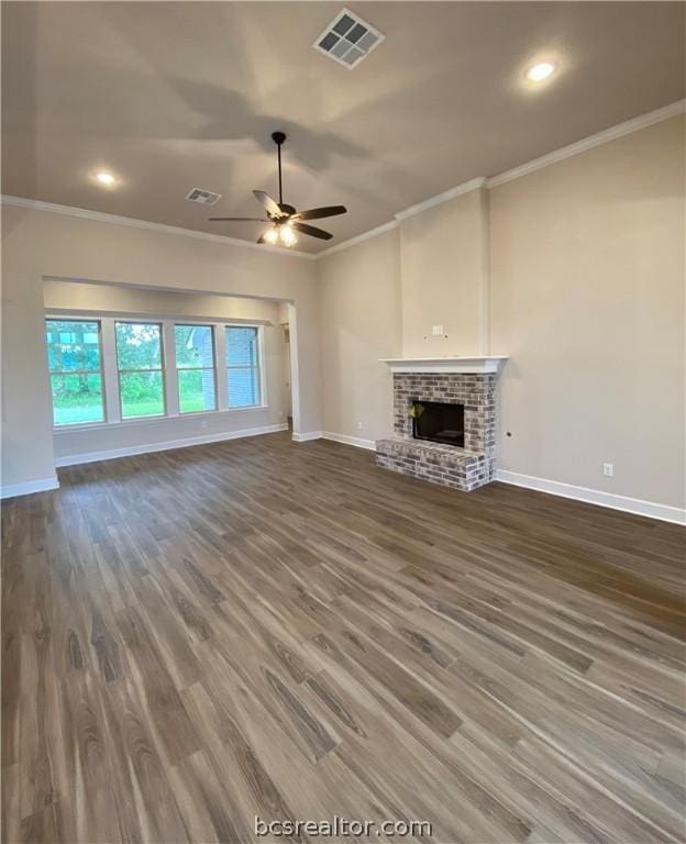 unfurnished living room featuring hardwood / wood-style floors, a brick fireplace, ceiling fan, and ornamental molding