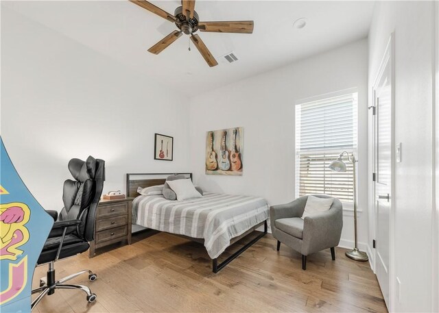 4435 Williams Lake Dr, College Station, TX 77845 - bedroom with a ceiling fan, baseboards, and light wood-style floors