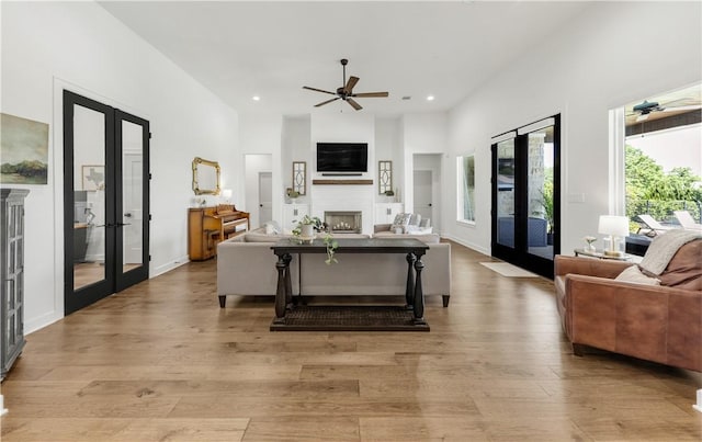 4435 Williams Lake Dr, College Station, TX 77845 - living area featuring ceiling fan, light wood-style flooring, french doors, and a fireplace