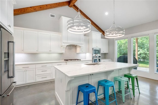 11188 Riley Green Rd, Franklin, TX 77856 - kitchen featuring appliances with stainless steel finishes, a chandelier, high vaulted ceiling, decorative backsplash, and white cabinetry
