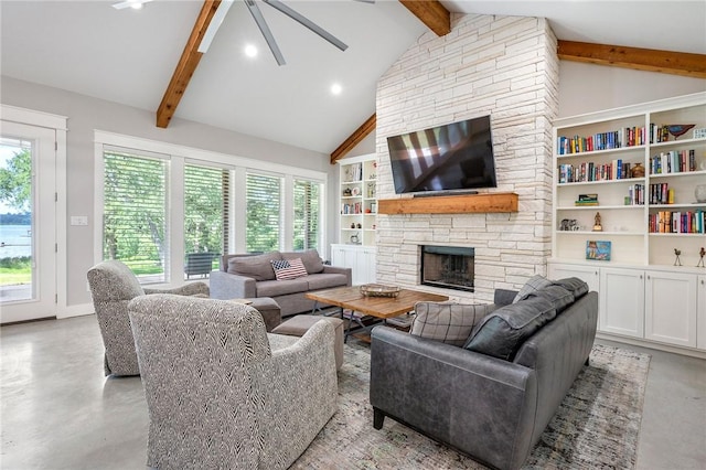11188 Riley Green Rd, Franklin, TX 77856 - living area with beam ceiling, finished concrete flooring, ceiling fan, healthy amount of natural light, and a stone fireplace