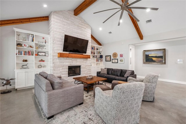 11188 Riley Green Rd, Franklin, TX 77856 - living area with ceiling fan, beam ceiling, finished concrete floors, built in shelves, and a stone fireplace