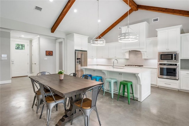 11188 Riley Green Rd, Franklin, TX 77856 - dining area with finished concrete floors, beamed ceiling, high vaulted ceiling, recessed lighting, and a chandelier