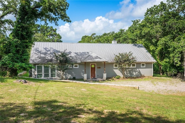 11188 Riley Green Rd, Franklin, TX 77856 - view of front of property featuring a front lawn, a chimney, and a metal roof
