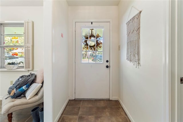 entryway featuring dark tile patterned floors