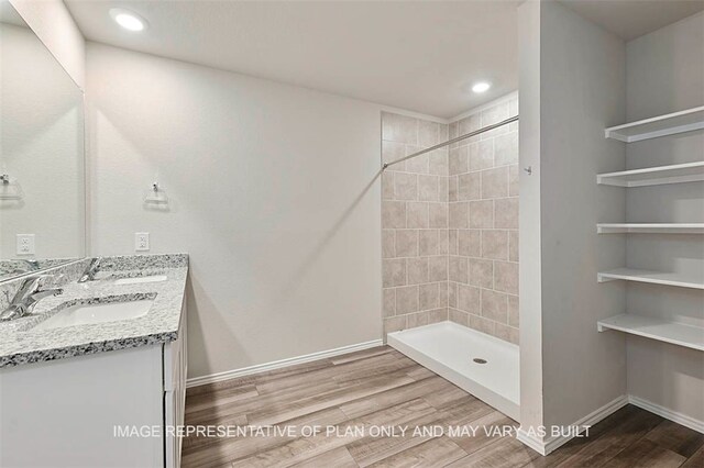 205 Rockbridge Dr, Huntsville, TX 77340 - bathroom with double vanity, wood finished floors, tiled shower, and recessed lighting
