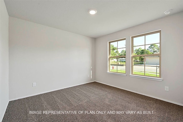 205 Rockbridge Dr, Huntsville, TX 77340 - spare room featuring dark carpet and a smoke detector