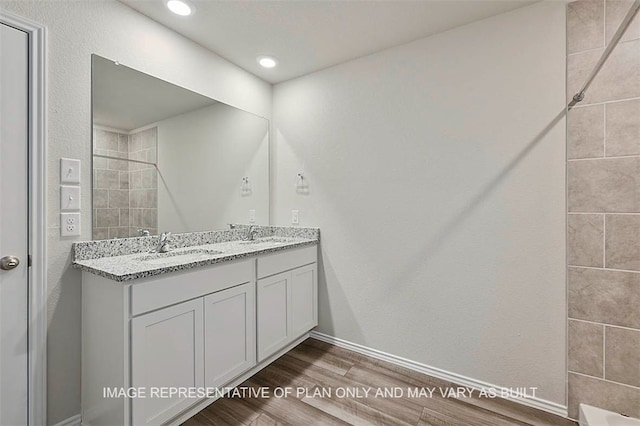 205 Rockbridge Dr, Huntsville, TX 77340 - full bathroom with double vanity, wood finished floors, tiled shower, and recessed lighting