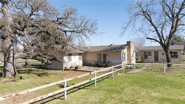 exterior space featuring french doors and a yard