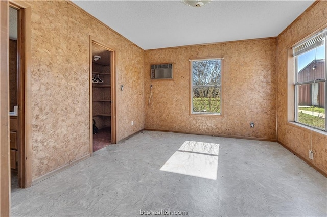 unfurnished room with a wall mounted AC