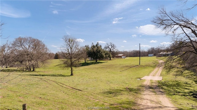 view of yard with a rural view