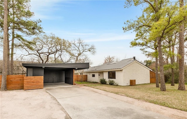 view of property exterior with a carport and a lawn