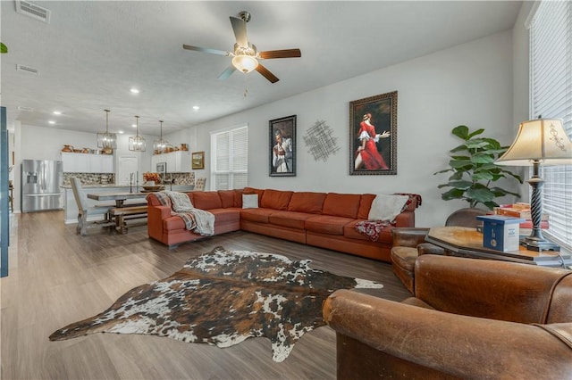 living room with hardwood / wood-style floors and ceiling fan