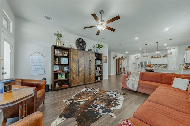 living room with dark hardwood / wood-style floors and ceiling fan