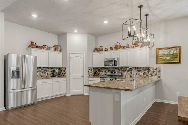 kitchen featuring white cabinetry, sink, kitchen peninsula, and stainless steel appliances