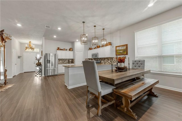 dining space with dark wood-type flooring