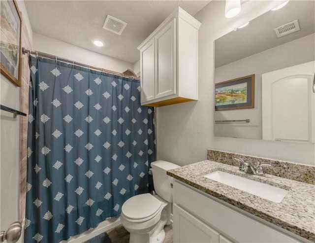 bathroom with vanity, toilet, and walk in shower