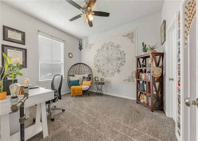 carpeted office space featuring ceiling fan