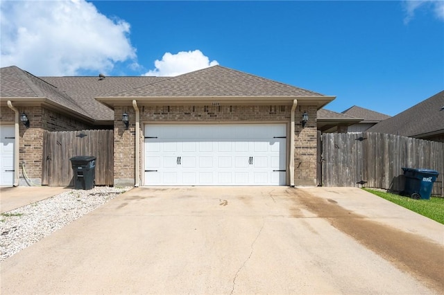 3609 Haverford Rd, College Station, TX 77845 - view of side of home featuring brick siding, an attached garage, and roof with shingles