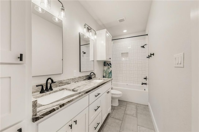 full bathroom with tiled shower / bath combo, vanity, tile patterned flooring, and toilet