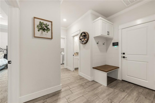 mudroom with washer / dryer and ornamental molding