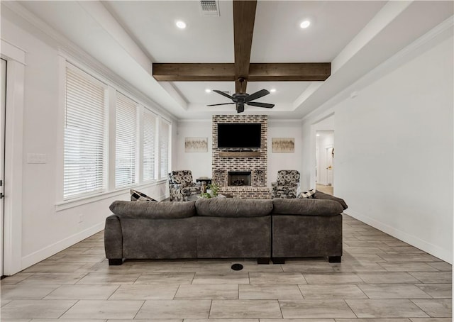 living room featuring coffered ceiling, ceiling fan, a fireplace, and beamed ceiling