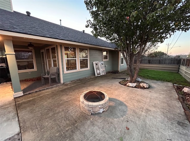 patio terrace at dusk featuring a fire pit