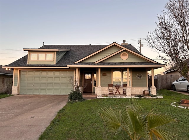 view of front facade featuring a garage and a yard