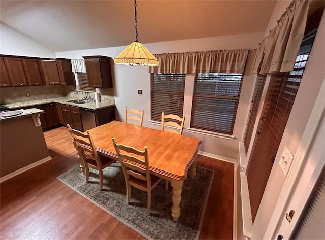 dining area with lofted ceiling, dark wood-type flooring, and sink