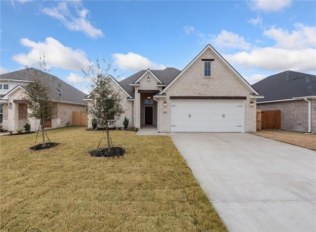 view of front facade featuring a garage and a front lawn