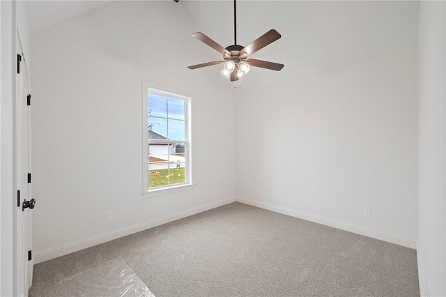 carpeted spare room featuring ceiling fan and lofted ceiling