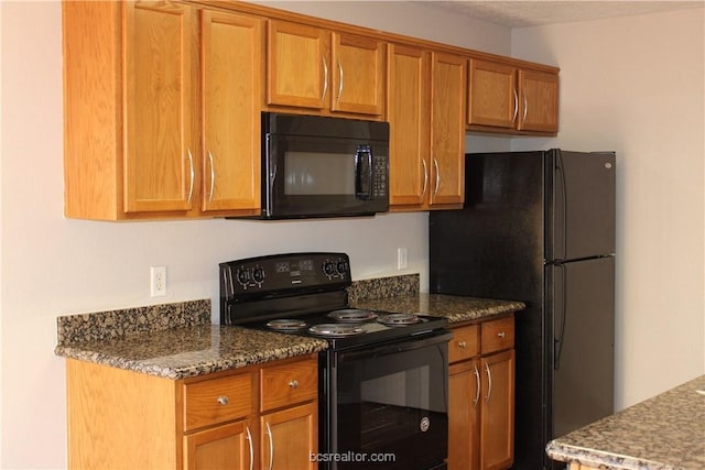 4031 Southern Trace Dr, College Station, TX 77845 - kitchen with black appliances, brown cabinetry, and dark stone counters