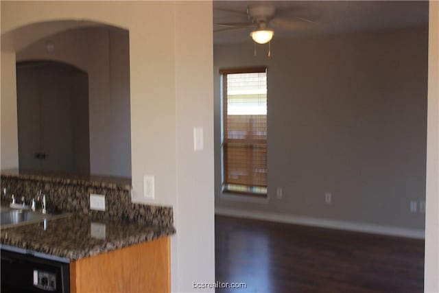 4031 Southern Trace Dr, College Station, TX 77845 - kitchen featuring wood finished floors, a ceiling fan, arched walkways, baseboards, and a sink