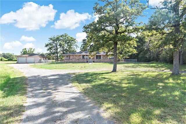 view of front of home featuring a front yard and a garage