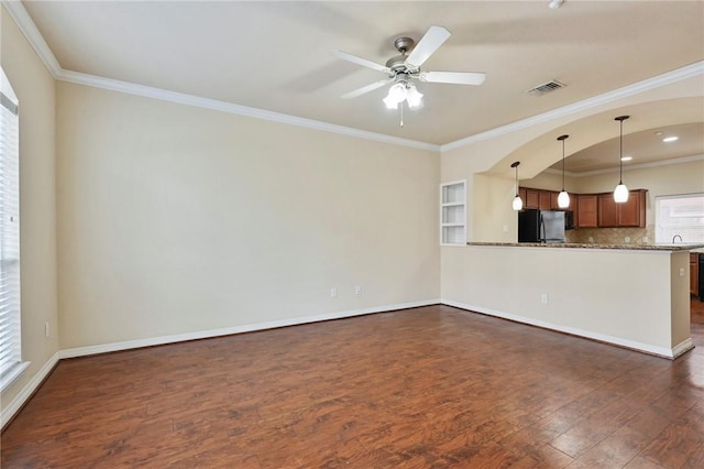 unfurnished living room with sink, ceiling fan, dark hardwood / wood-style flooring, and crown molding