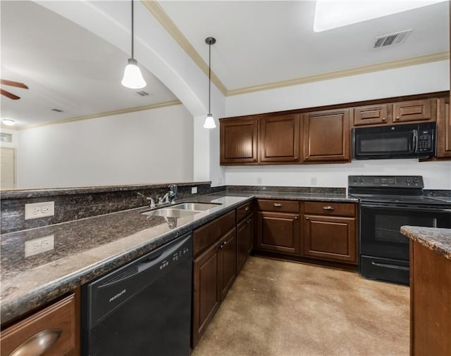 kitchen with crown molding, dark stone countertops, hanging light fixtures, a sink, and black appliances