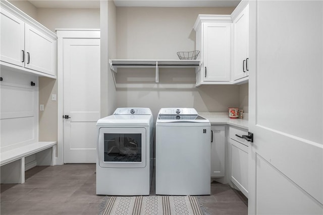 washroom with cabinets and separate washer and dryer