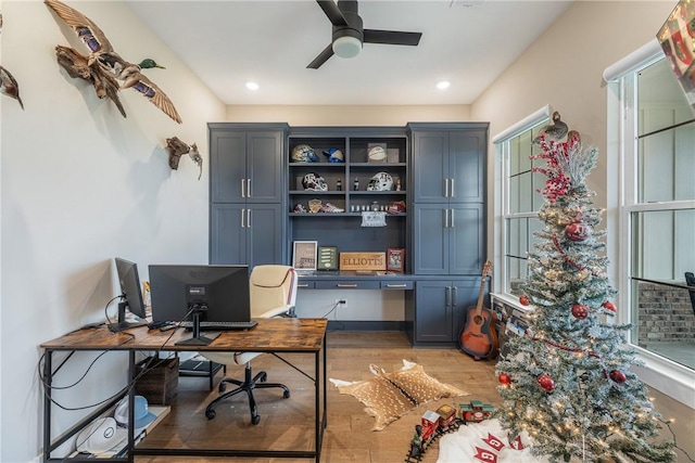 home office featuring hardwood / wood-style floors and ceiling fan