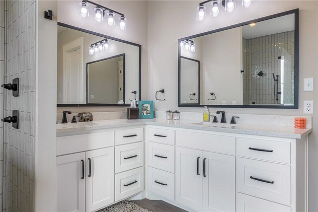 bathroom featuring vanity and tiled shower