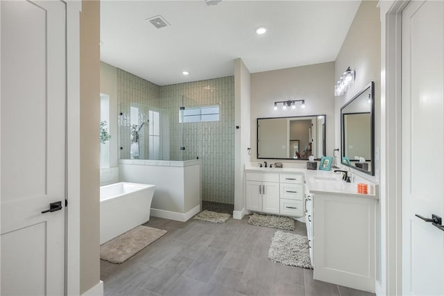 bathroom with vanity and separate shower and tub