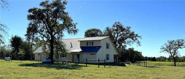 rear view of house featuring a lawn