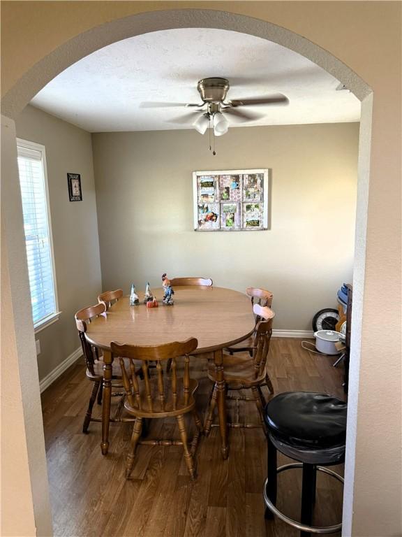 dining space with ceiling fan and hardwood / wood-style floors