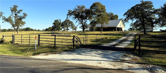 view of gate with a rural view